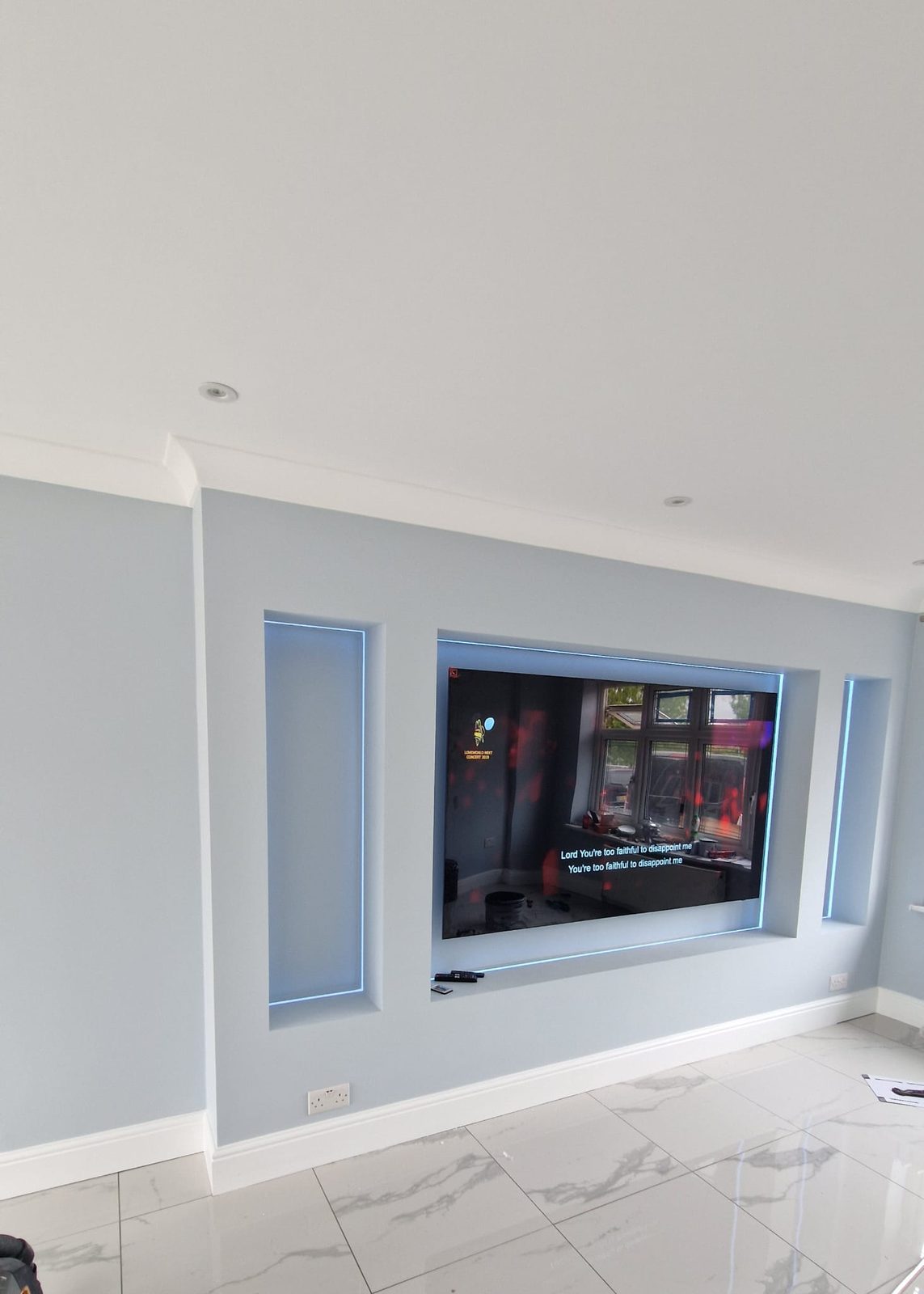 Media wall with recessed TV and backlit alcoves