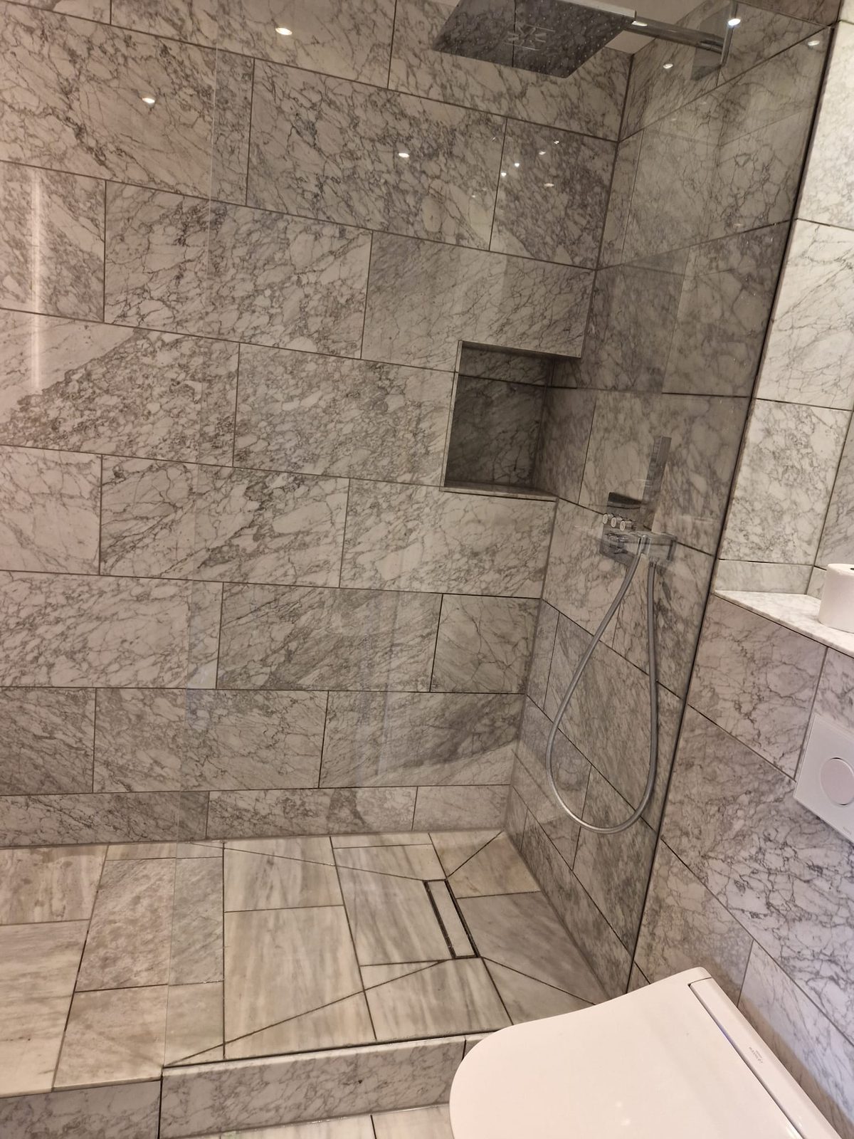 Marble wet room with rainfall shower and niche
